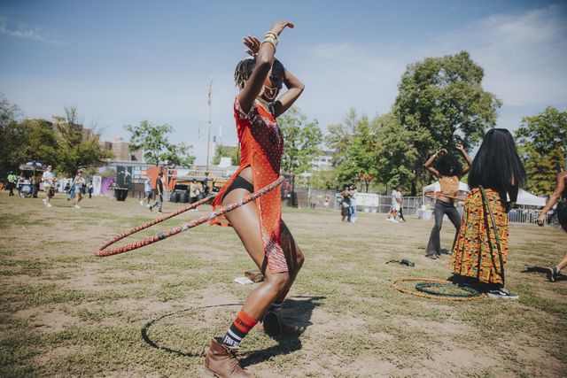 A young woman dancing with a hula hoop